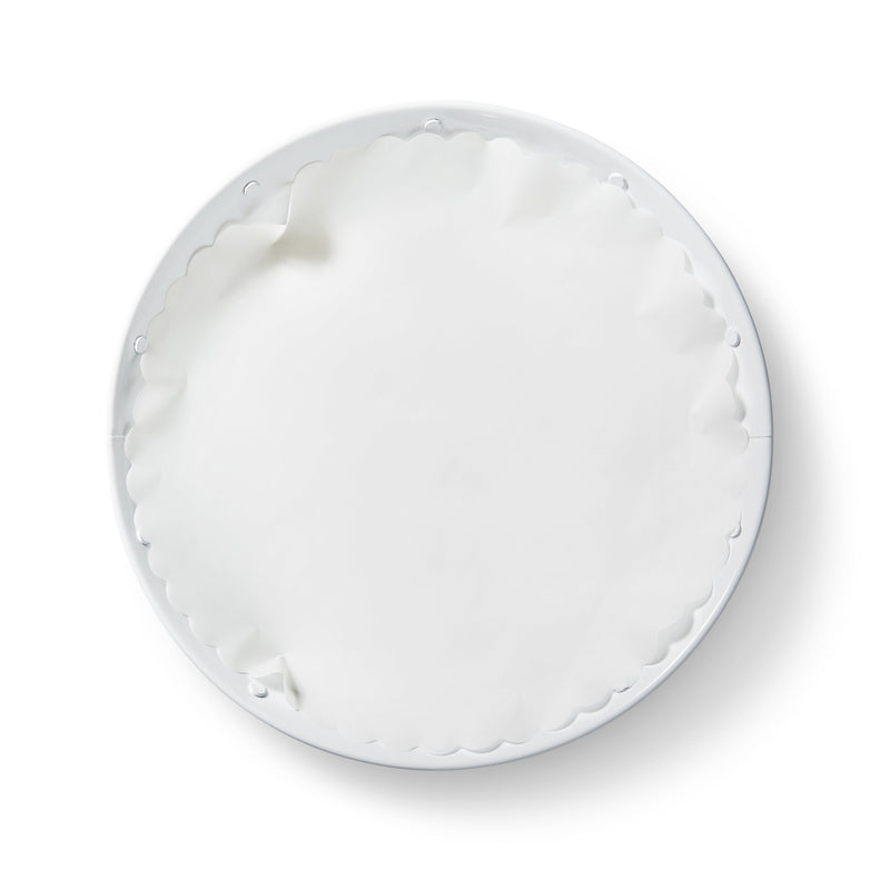 Close-up of the 'Classic White' Original Flat Plate Liners on a white plate, highlighting the product's smooth, oval design from Athens Cooks kitchen store.