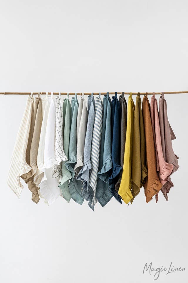 MagicLinen's ruffle trim tea towels hang neatly, showcasing their soft, absorbent linen fabric, perfect for enhancing any kitchen's style and functionality.
