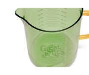 Great Jones | Beyond Measure 4-Cup - Broccoli-Butternut glass measuring cup with clear measurements, precision-pour spout, ideal for kitchen prep and serving.