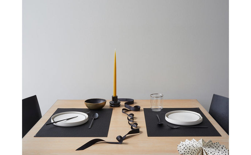 Chilewich Basketweave Rectangle Placemat on dining table with plates and candle, showcasing its intricate design suitable for enhancing any kitchen or dining space.