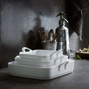 Pillivuyt | Toulouse Square Baker - 8.5, shown stacked with other white ceramic dishes, perfect for baking and serving, featured at Athens Cooks.