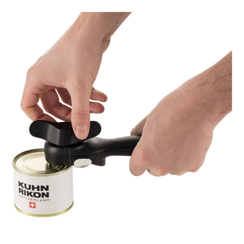 Hands using Kuhn Rikon | LidLifter, Black, effortlessly open a metal can, showcasing its ergonomic design and self-attaching feature for safe, clean, and easy can opening.