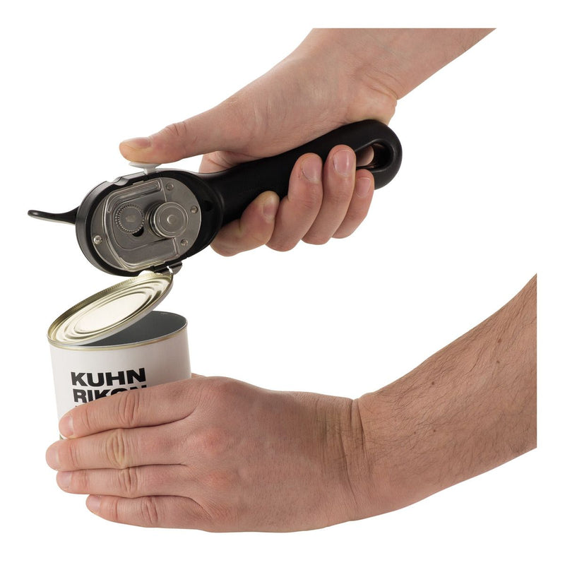 Kuhn Rikon LidLifter in use, lifting a can lid effortlessly with its self-attaching design, ensuring no sharp edges for safe, easy opening.