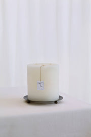 Mo&Co Home - 200h Burn | GRAND Beeswax Pillar Candle displayed on a metal tray, highlighting its elegance and long-lasting, artisanal quality, perfect for gifting.