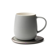 OHOM - Ui 3 Self-heating Mug Set: Soft Gray on a metallic base, designed to maintain beverage warmth and wirelessly charge devices, reflecting modern functionality.