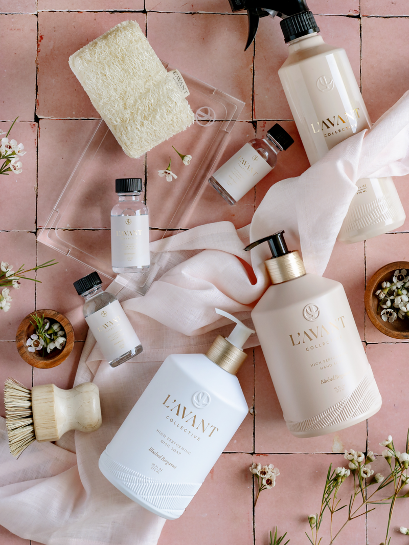 L'AVANT Collective - High Performing Hand Soap - Blushed Bergamot in elegant blush pink bottle, showcased among various skincare products.