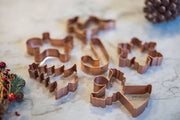 Galley and Fen - Christmas Cookie Cutters - Set of 6 on marble surface, featuring holiday shapes like Christmas tree, gingerbread, and snowflake, perfect for festive baking.