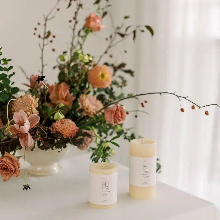 Mo&Co Home - 100% Beeswax Pillar Candles showcased with a garden-style bouquet, embodying natural elegance for home decor and special occasions.