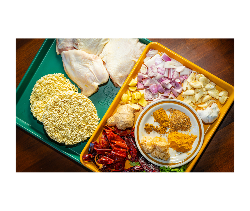 Great Jones | Little Sheet - Pepper, a quarter-sized nonstick sheet pan, ideal for baking small batches or reheating, showcased on a table at Athens Cooks.