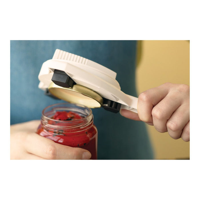 A person using the Kuhn Rikon Gripper Jar Opener to easily open a jar of red sauce.