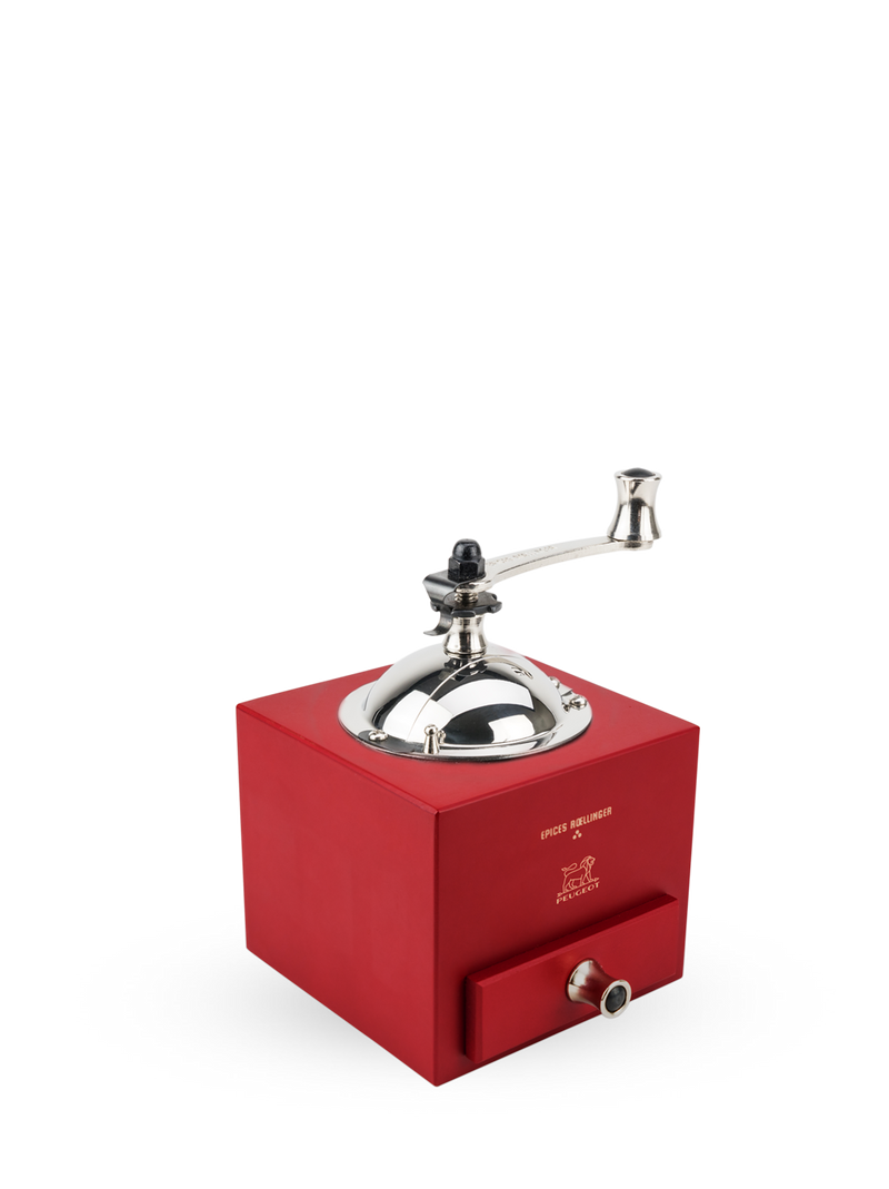Peugeot | Roellinger Pepper Mill, Red: A vintage-style grinder with a hand-crank, metal dome, and front drawer, embossed with the Peugeot logo, blending modernity and tradition.