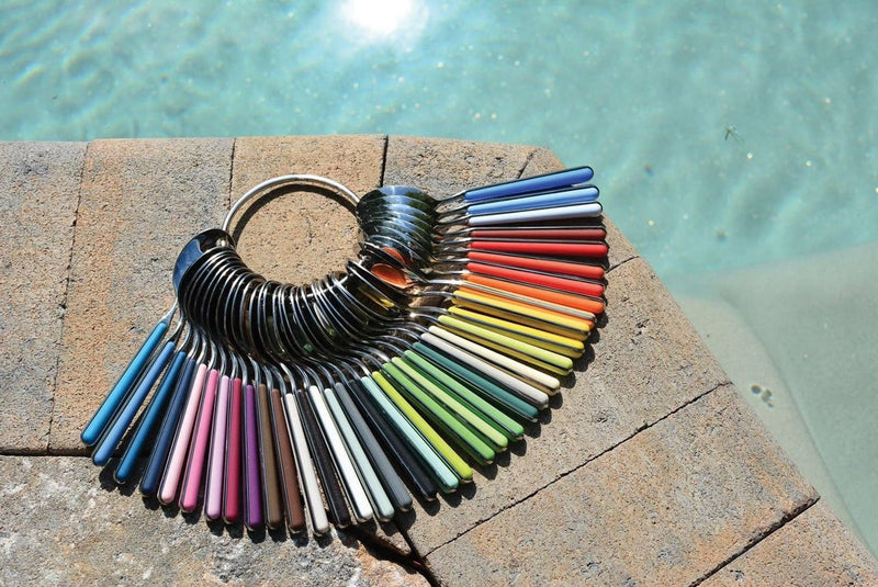 Mepra SPA - 2 Pcs Serving Set Fantasia Carrot featuring elegant spoons and forks on a stone surface, crafted from 18/10 stainless steel and resin.