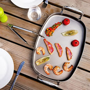 De Buyer | Mineral B Element Rectangular Pan with two handles on a tray, showcasing its culinary use.