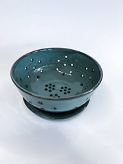 RachaelPots - Large Berry Bowl With Dish: Black, featuring a teal-glazed ceramic colander with floral drainage holes and matching saucer, ideal for rinsing and displaying produce.