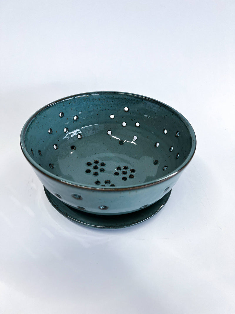 RachaelPots - Large Berry Bowl With Dish: Black, featuring a teal-glazed ceramic colander with floral drainage holes and matching saucer, ideal for rinsing and displaying produce.