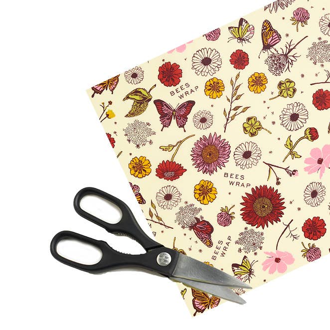 Bee's Wrap - Cut-to-Size Roll - Meadow Magic, Plant-Based Wax with floral-and-butterfly design, shown with scissors for customization, ideal for eco-friendly kitchen use.