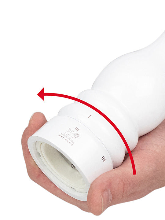 Hand adjusting the grind setting on the Peugeot | Paris u'Select Salt Mill Wood, White Lacquer, 9 inches, highlighting its precise u'Select system.