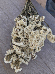 Alissas Flower Farm - Wreath: Stuffed with Statice in rose shades, displayed on a wooden surface, highlighting its natural, dried floral arrangement.