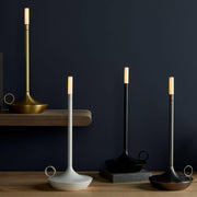 VANMOKUM | GRAYPANTS Wick Portable Rechargeable Lamp displayed among elegant candlesticks, highlighting its versatile design for intimate or bustling settings.