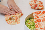 Wrapping cheese with Bee's Wrap - Assorted 3 Pack - Mushroom Magic, Limited Edition. Bowl of salad partly covered with the same reusable wrap nearby.