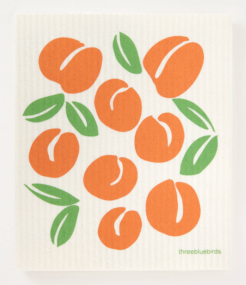 Swedish dishcloth featuring orange fruits and green leaves design, perfect for reducing waste in the kitchen; absorbs 20x its weight.