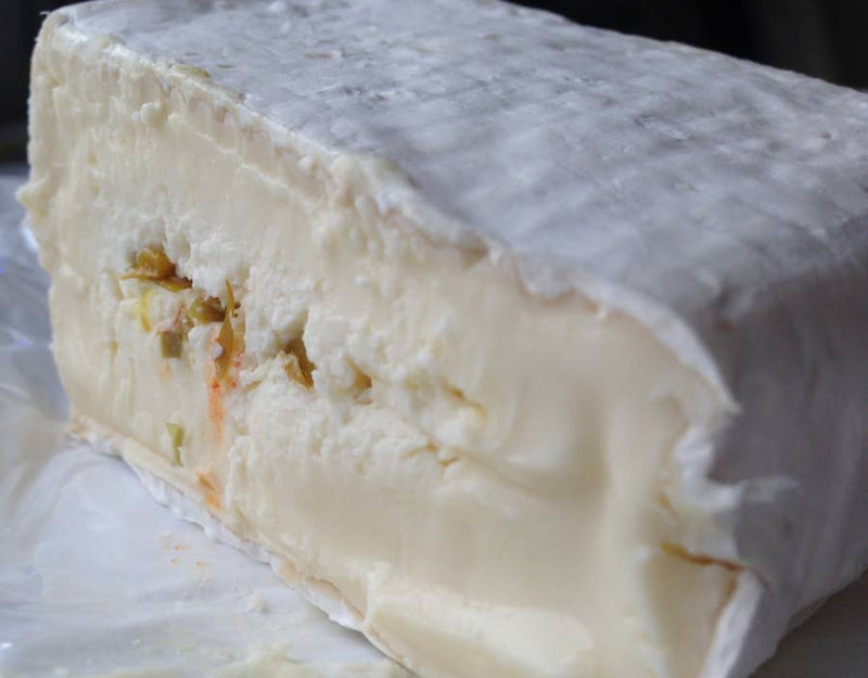 Tulip Tree Creamery - Snapdragon: A triple cream, soft-ripened cheese with habanero peppers, featuring a creamy interior and white rind, perfect for spicy food enthusiasts.
