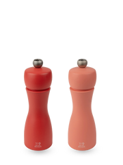 Peugeot | Tahiti Duo Salt + Pepper Mills, Fire: A matching set of red and coral-pink manual grinders, each with an adjustment knob and Peugeot lion logo.