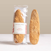 Potters Table - Salted Olive Oil Flatbreads, hand-stretched and golden-brown, one wrapped showing label, ideal for pairing with spreads or cheese.