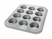 USA Pan | Muffin Pans - 12 Cup Muffin Pan & Lid Set, featuring twelve metal cups for baking muffins or cupcakes, with a durable, nonstick surface.