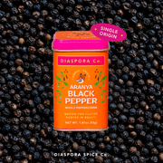 Diaspora Spices Co. - Aranya Black Pepper (Whole) in a 53g tin, displayed on peppercorns. Single-origin spice from Parameswaran family farm, known for flavorful depth.