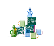 Great Jones | Beyond Measure 4-Cup - Broccoli-Butternut: Close-up of a glass measuring cup with printed measurements and a pink handle, ideal for precise kitchen use.