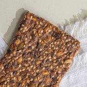 Potters Table - Gluten-Free Seeded Crisps: Close-up of a crunchy whole-grain cracker with embedded seeds, showcasing its texture and health-focused ingredients. Ideal for keto or vegan diets.