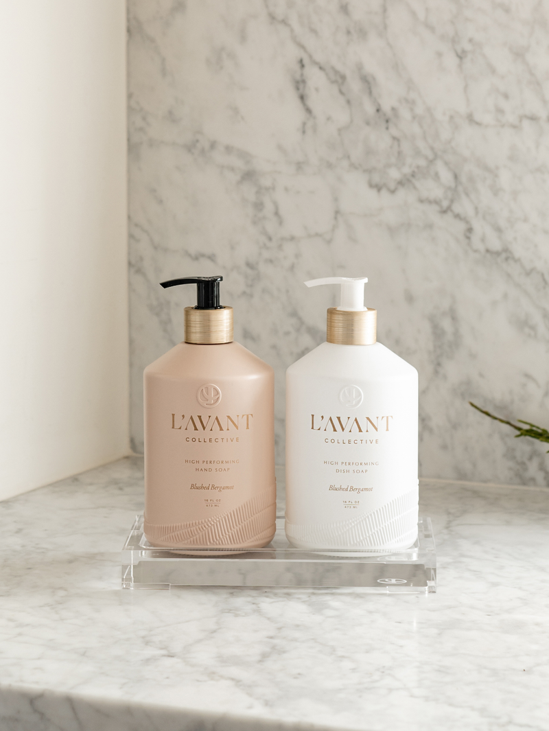 L'AVANT Collective - High Performing Dish Soap - Blushed Bergamot in matte white bottles on a countertop, perfect for luxurious cleaning.