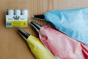 India Tree - Nature's Colors Decorating Set: 2.25 oz, featuring bags of plant-based food coloring for vibrant icing, displayed on a table.
