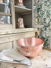 Coppermill Kitchen LLC - Coppermill Vintage Inspired Mixing Bowl, a hammered copper bowl with ring handle, showcased in a rustic kitchen setting, alongside a whisk and linen cloth.