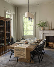 Coral & Tusk - Thistle Dinner Napkin elegantly set on a farmhouse table, enhancing a classic dining room with embroidered botanical motifs and a matching table runner.