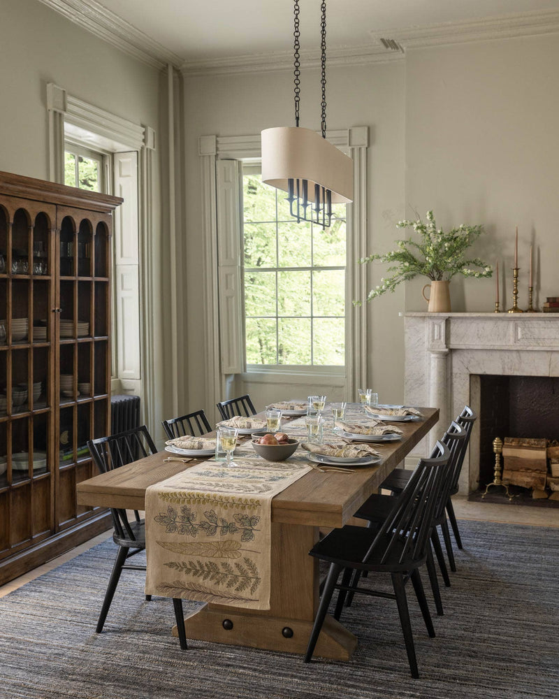 Coral & Tusk - Thistle Dinner Napkin elegantly set on a farmhouse table, enhancing a classic dining room with embroidered botanical motifs and a matching table runner.