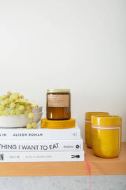 Graf Lantz - Bierfilzl Merino Wool Felt Round Coaster Solid 4 Pack: Turmeric displayed with elegant table decor, showcasing its refined modern design and heritage element.