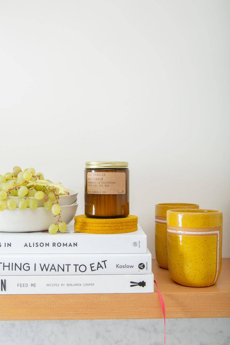 Graf Lantz - Bierfilzl Merino Wool Felt Round Coaster Solid 4 Pack: Turmeric displayed with elegant table decor, showcasing its refined modern design and heritage element.