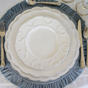 Bella Bianca Antique Lace Salad/Dessert Plate, Italian stoneware with intricate patterns, accompanied by silverware on a table, ideal for elegant dining settings.