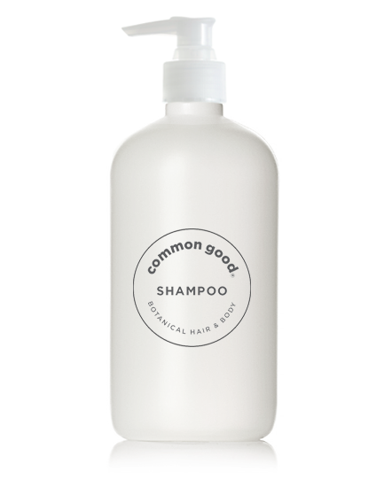 A white pump bottle labeled "Common Good" and "Botanical Shampoo & Conditioner" at the center, designed for botanical hair and body care. This all-natural shampoo has a clean and minimalistic appearance with black text, featuring a botanical blend that includes essential oils for a refreshing cleanse.