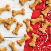 Nordic Ware | 2 Piece Puppy Love Treat Pan and Dog Treat Mix featuring homemade dog treats on a red cloth, highlighting the baking results.
