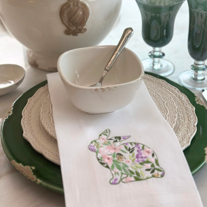 Arte Italica & Crown Linen Designs' Garden Bunny Towel displayed among elegant serveware, showcasing its embroidered floral toile bunny design, perfect for Easter celebrations.