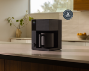 FELLOW - Aiden Precision Coffee Maker: Matte Black on a kitchen counter, ideal for brewing pour-over style coffee with precision and ease.