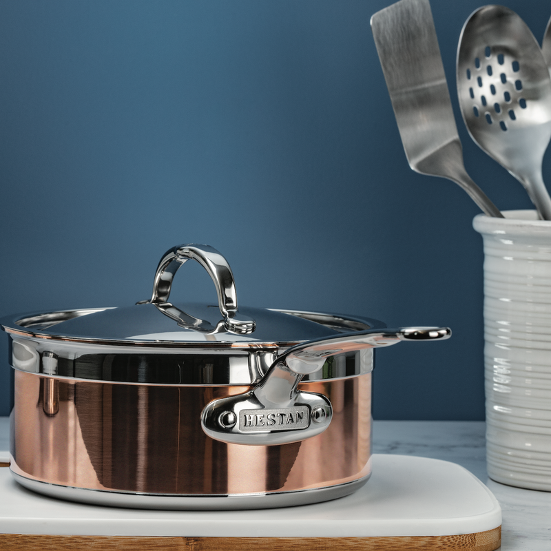 Hestan Provisions | Stainless Steel Lids Dome, 14 on saucepan, shown with utensil crock; designed for optimal heat retention and flavor preservation.