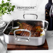 Hestan Provisions Classic Roaster with Rack, 14.5 Inches, showcasing herb-roasted beef cuts; premium stainless-steel construction ideal for versatile cooking, displayed at Athens Cooks.