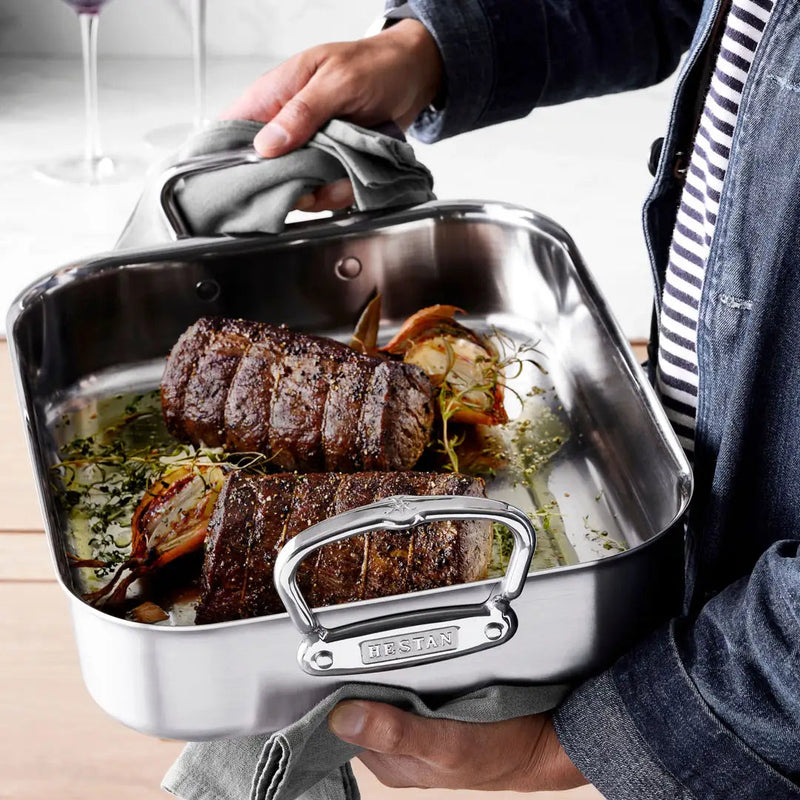 Hestan Provisions | Classic Roaster with Rack, 14.5 Inches, showcasing two beef roasts, onions, and herbs, emphasizing durable stainless-steel craftsmanship for optimal roasting.