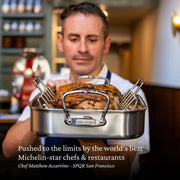 Chef Matthew Accarrino holds a Hestan Provisions Classic Roaster with Rack, 14.5 inches, showcasing its stainless-steel craftsmanship and professional-grade design for optimal kitchen performance.