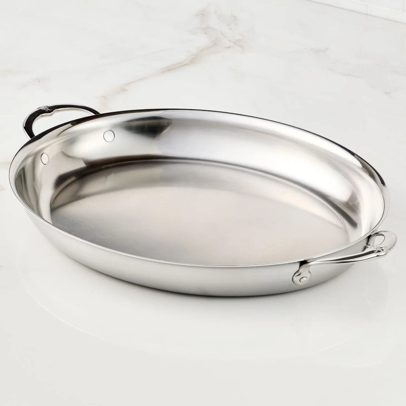 Hestan Provisions | Large Clad Oval Roaster with polished stainless steel finish and riveted loop handles, designed for versatile cooking and elegant table presentation.