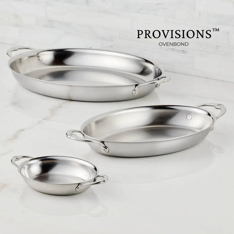 Hestan Provisions | Large Clad Oval Roaster set with loop handles on marble, showcasing premium stainless steel craftsmanship for both professional chefs and home cooks.